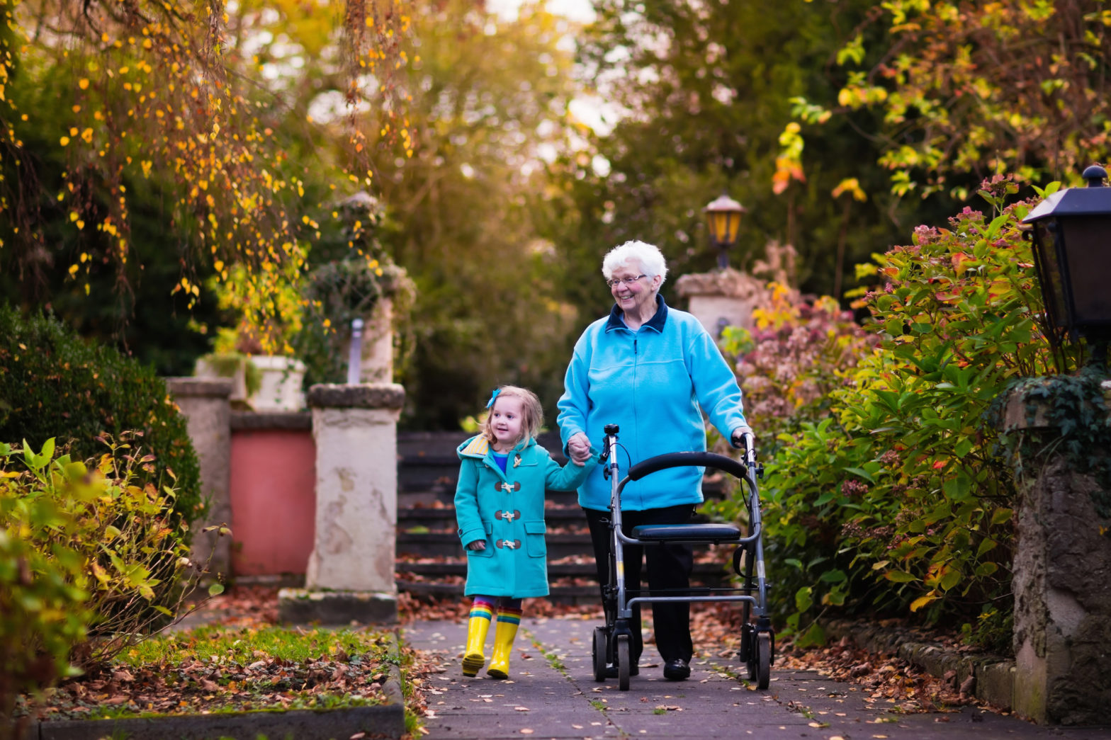 elderly woman walking with a young child