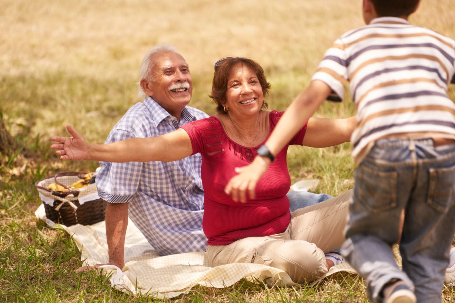 grandson running with arms open to grandparents