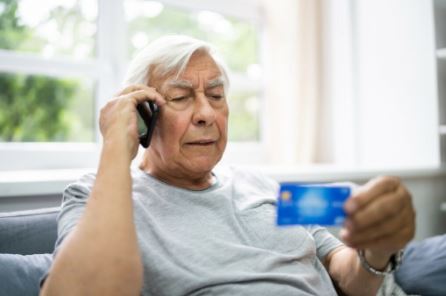 man on phone with credit card