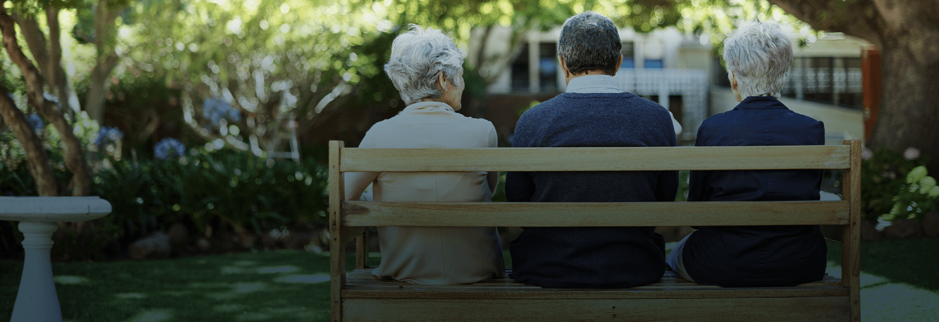 Senior group of friends sitting on an outdoor bench