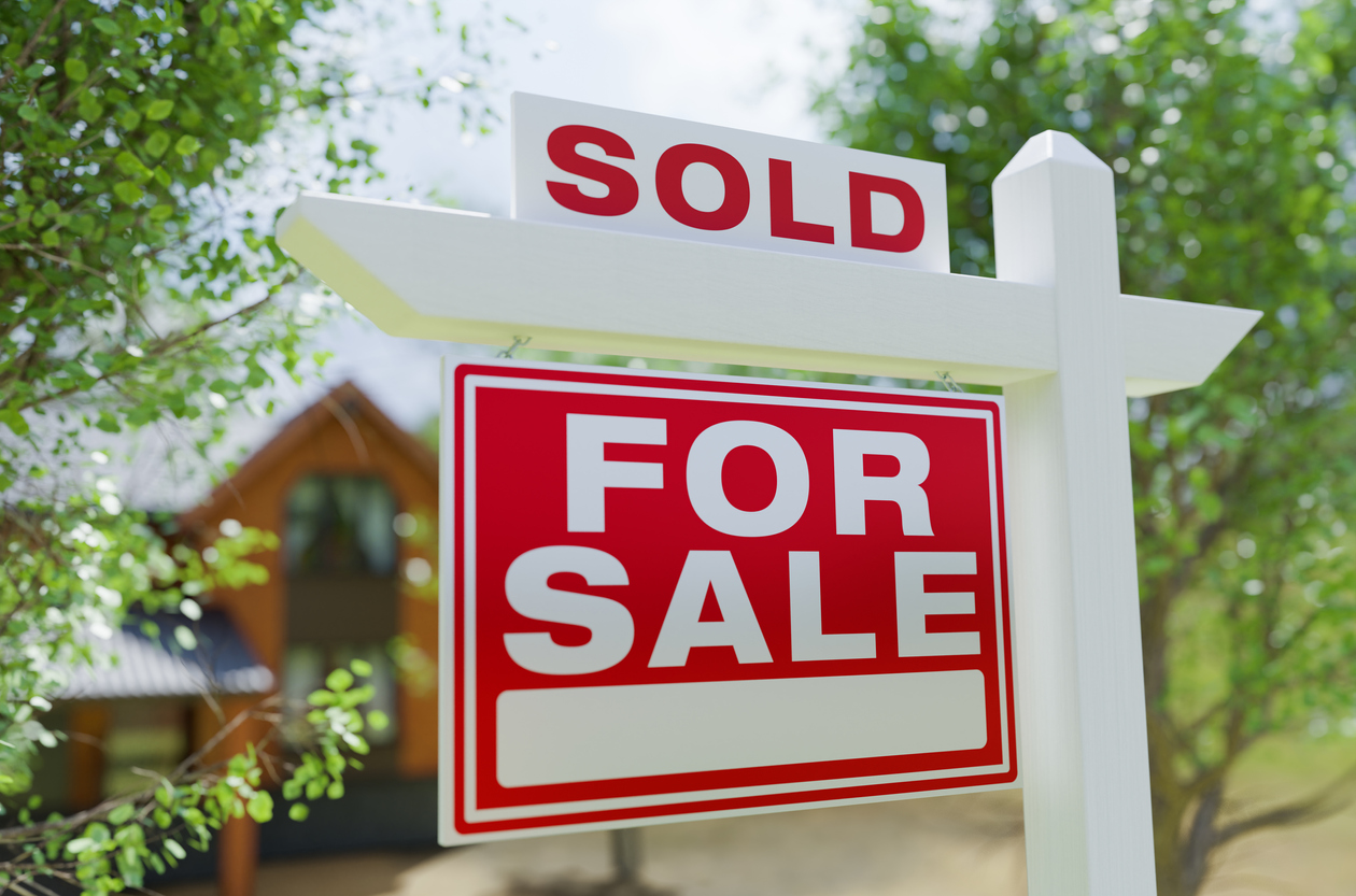 For Sale Real Estate Sign In Front of Property.