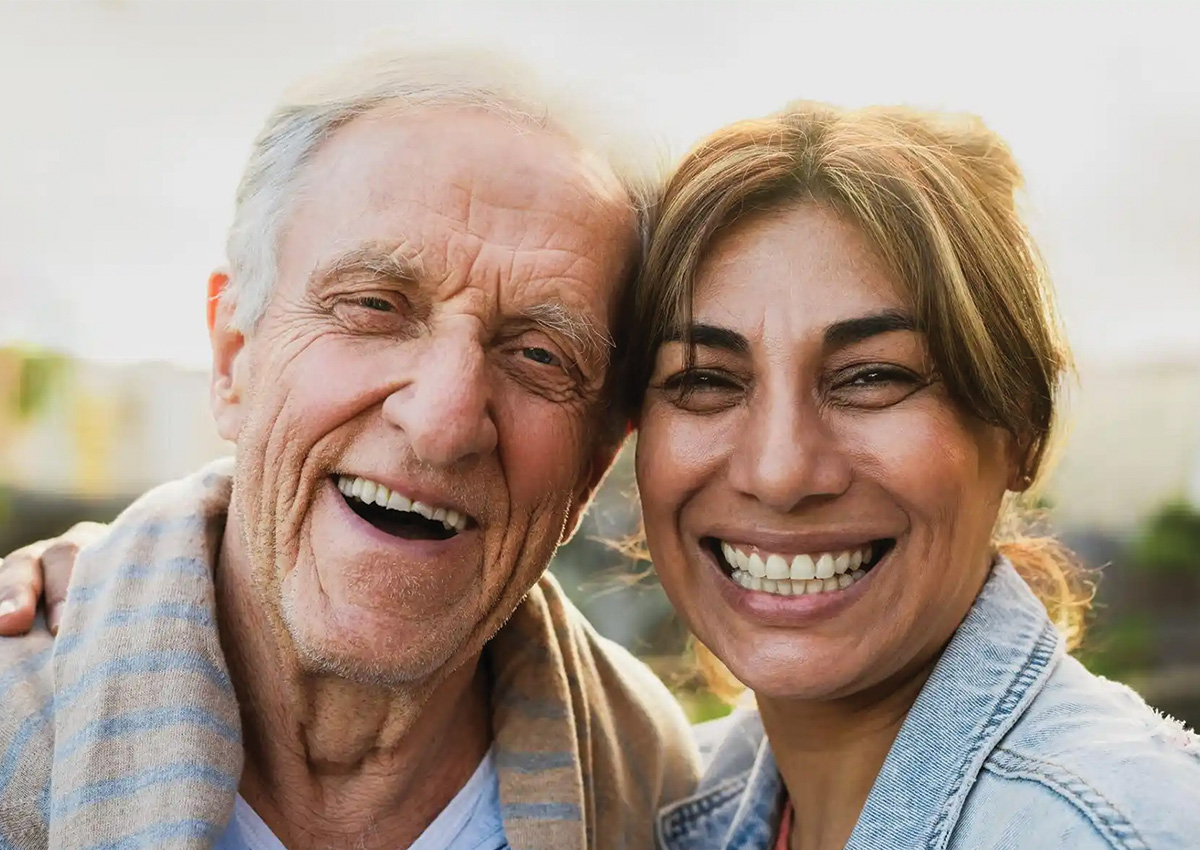 Senior father and adult daughter laughing