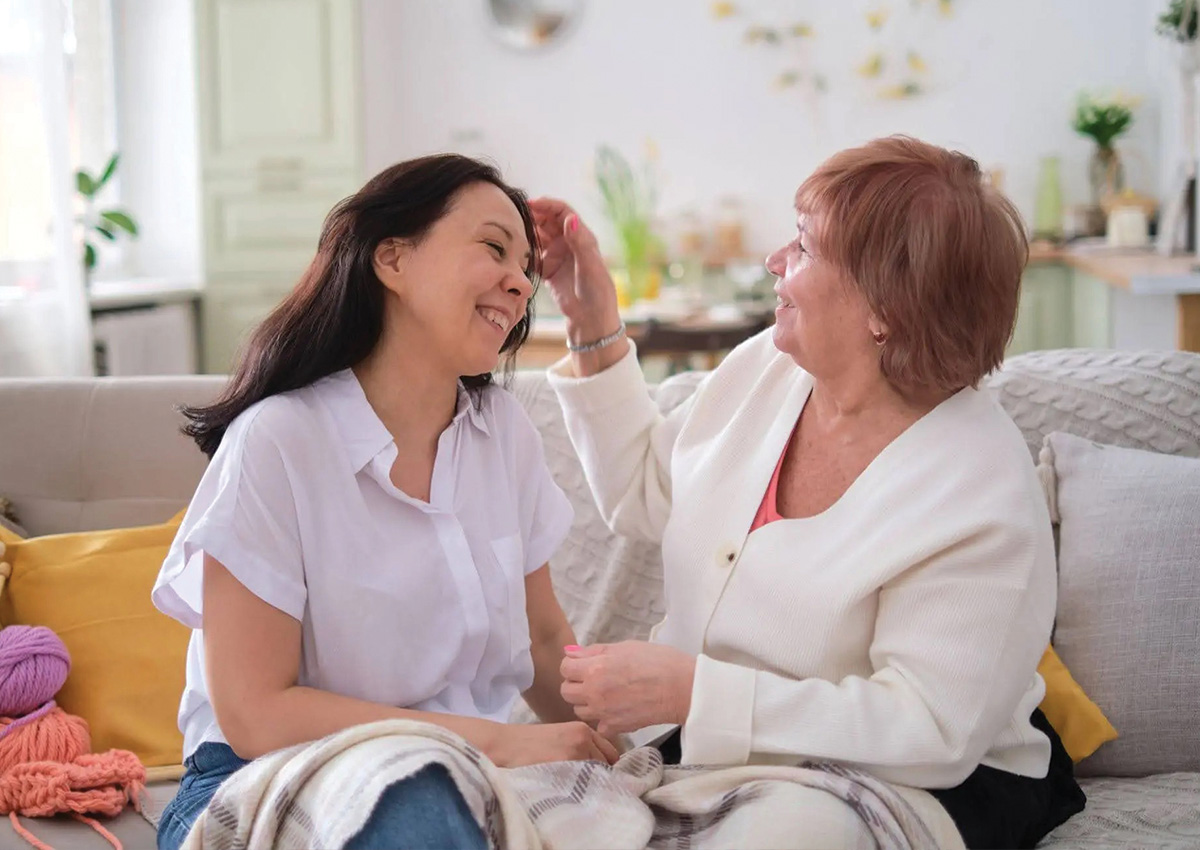 Adult mother and daughter laughing